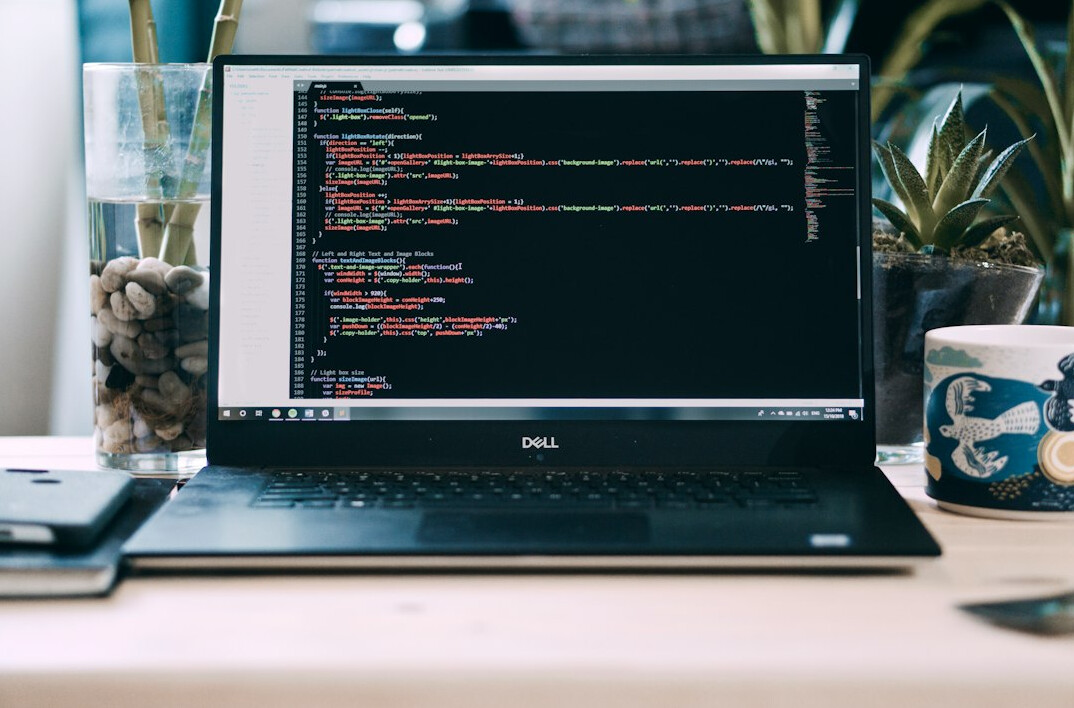 programmer coding on laptop