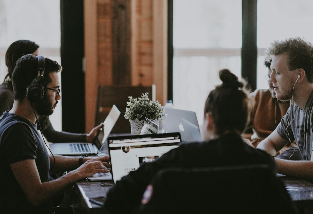 project team using it tools in meeting