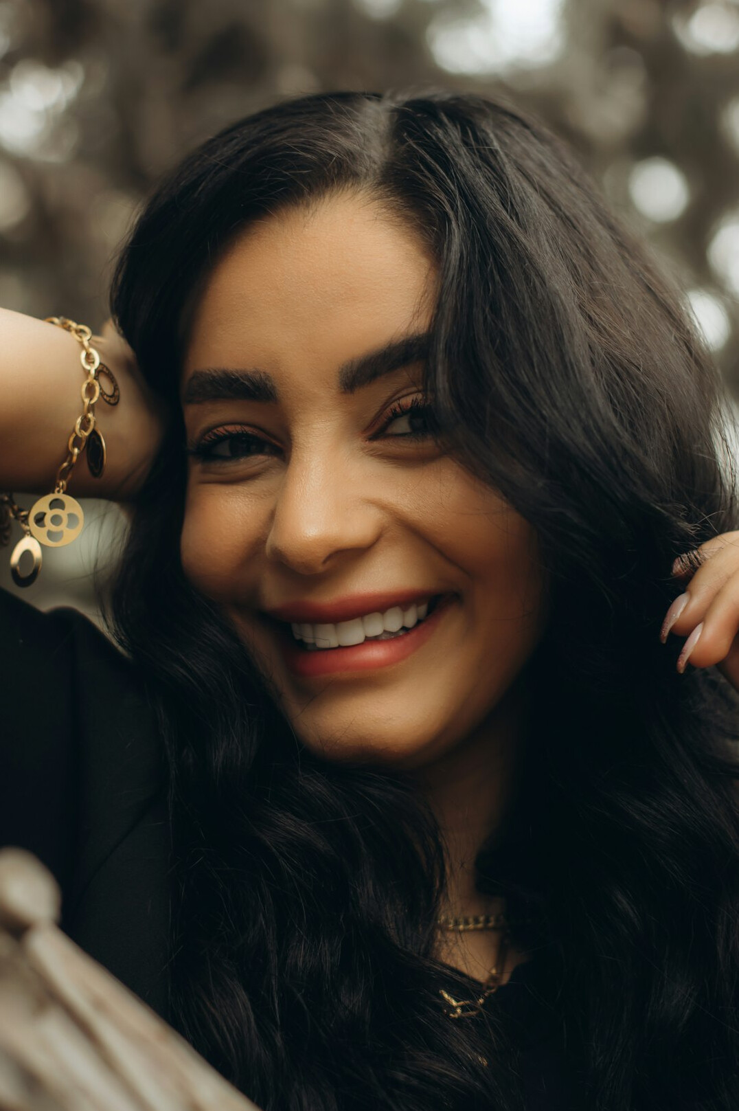 Studio portrait of a professional woman with dark hair smiling